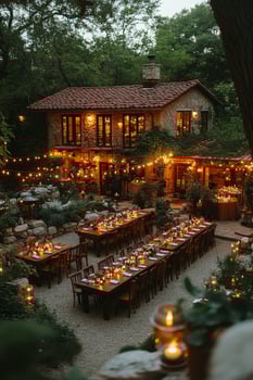 Beautiful outdoor wedding reception with elegant tables and festive lights at sunset photo