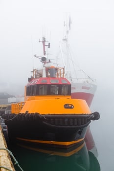Fishing vessels in a foggy misty morning at Harbor photo