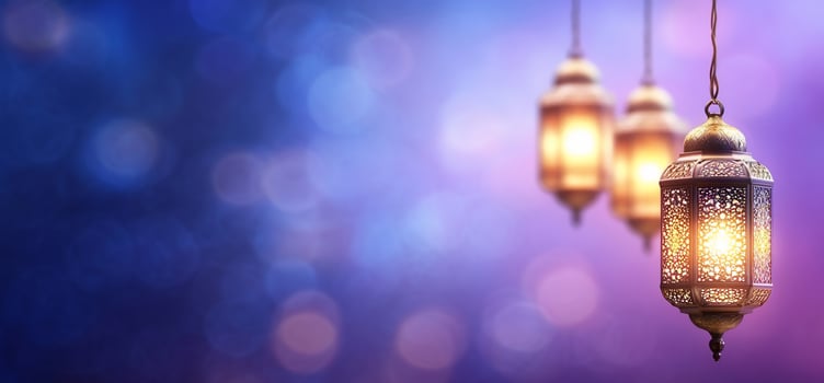 Three lamps hanging from a string on a purple background photo
