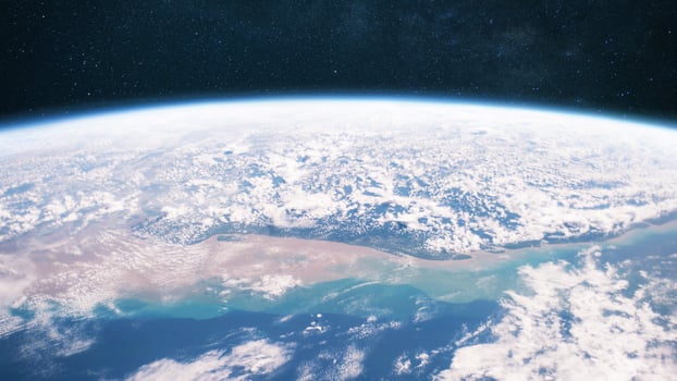 Beautiful blue planet earth with ocean, clouds and continents in open space on the starry sky. photo