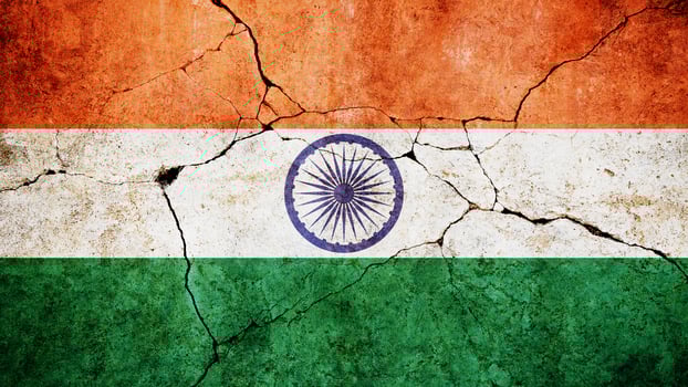 India flag on cracked damage concrete wall, concept. Economy and crisis, creativity. Freedom and patriotism photo