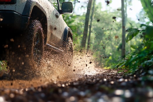 A vehicle driving on a dirt road photo