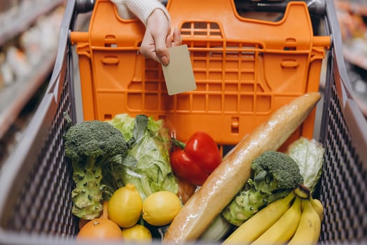 Customer paying with credit card for groceries in supermarket cart photo