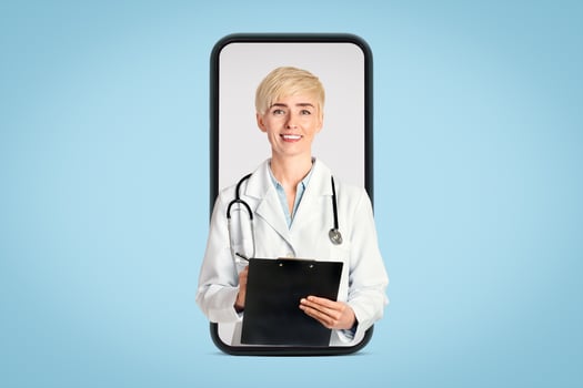 Medical professions, healthcare and prevention. Smiling adult woman in white coat with stethoscope taking notes in tablet and looking at camera isolated on gray background, cut out, free space photo