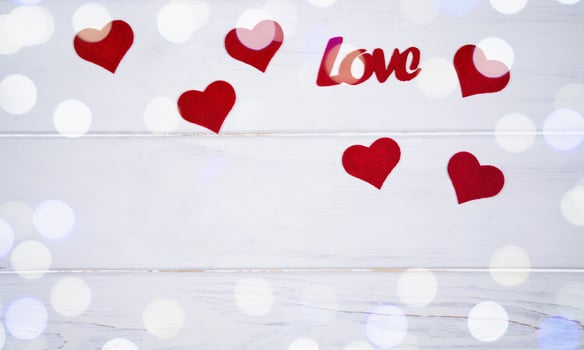 Valentine's Day holiday concept. Red hearts and word Love on white wooden background. Banner. Top view. Flatlay. Copy space. photo