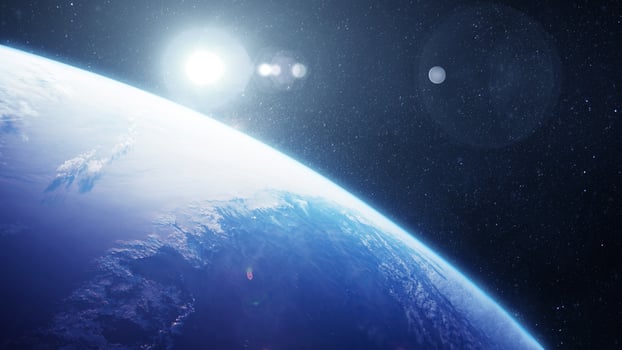 Beautiful blue planet Earth with clouds in space with stars and sun, creative idea. Space wallpaper and planet photo