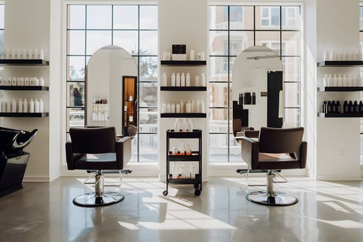 Modern salon with styling chairs, sunlight enhances sophisticated, polished interior photo