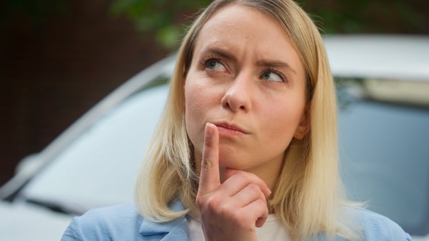 Confused puzzled Caucasian female owner driver woman thinking idea car problem car breakdown wonder pensive auto buyer deciding in city business businesswoman contemplate automobile girl ponder dream photo