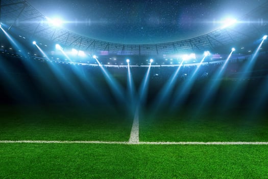 Modern football stadium with green lawn and blue spotlight. Soccer background. Football champions photo