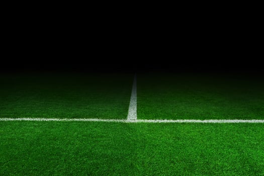 Soccer Stadium at night. Football and green field in the dark photo