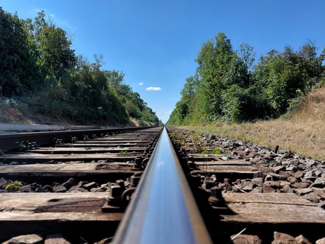 Looking closely over a straight rural railway track photo