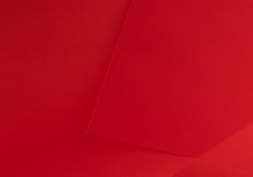 Scarlet red paper background with a rich, vibrant gradient and smooth texture. Premium material with photo