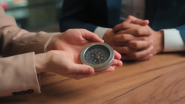 Businessman businesswoman Arabian man Muslim woman in hijab male female business partners hold compass search direction navigation in financial world rotating pointer trade stock market money success photo