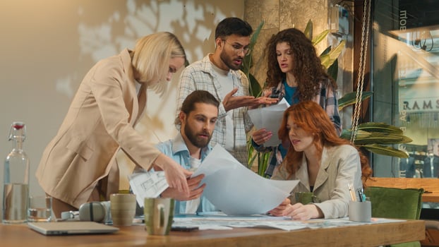 Different colleagues angry men women girls guys male female fight argue throw papers shout scream stress disagree problem trouble group conflict quarrel negative emotions diverse business team office photo