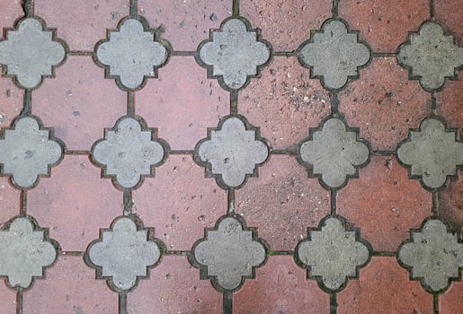 Wet red patterned paving slabs. Outdoor tile background. photo