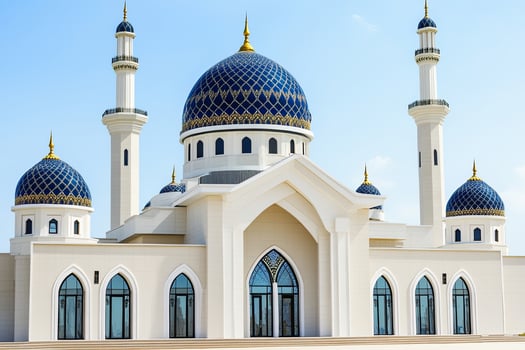 Majestic mosque with blue domes, minarets, and intricate details under a clear sky. photo
