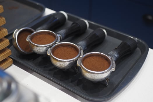 Four Coffee Portafilters Are Prepared and Ready for Brewing a Perfect Cup photo
