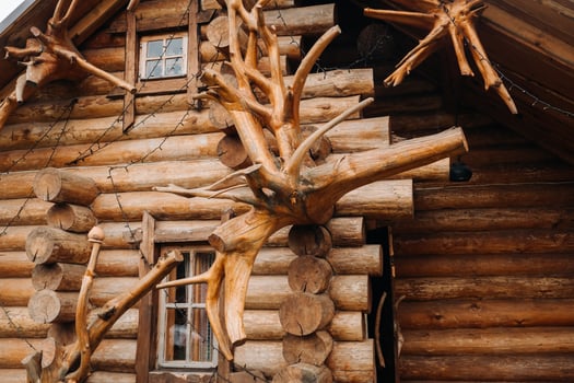 Beautiful carved wooden house in the village of logs and farmyards photo