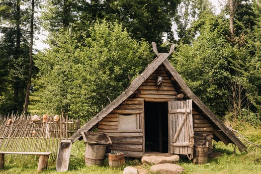Triangular log houses with wooden roofs behind a fence. Montenegro, north photo