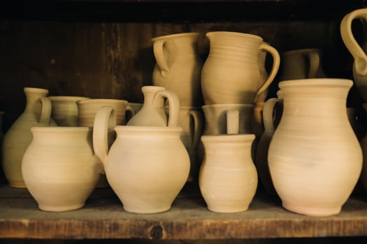 Ceramic clay jugs standing on a shelf in the village photo