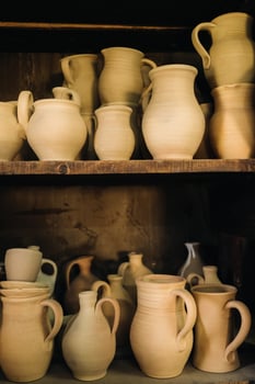 Ceramic clay jugs standing on a shelf in the village photo