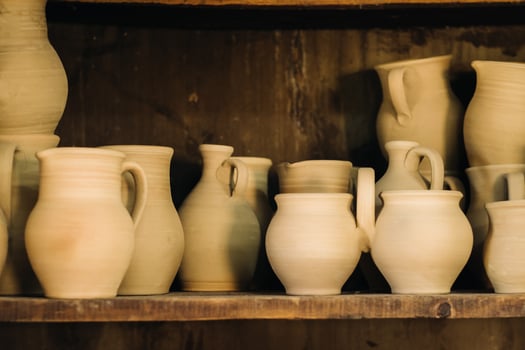Ceramic clay jugs standing on a shelf in the village photo