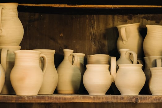 Ceramic clay jugs standing on a shelf in the village photo