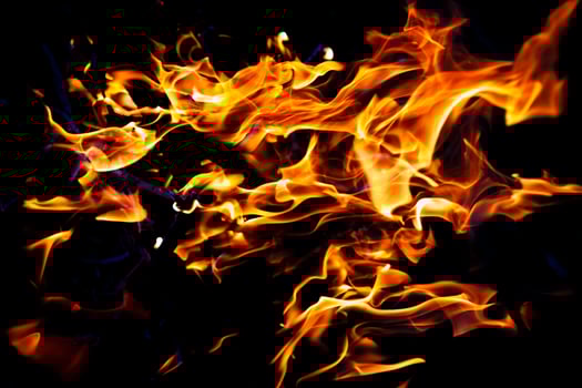 fire burning on a black background. Red fiery flame photo