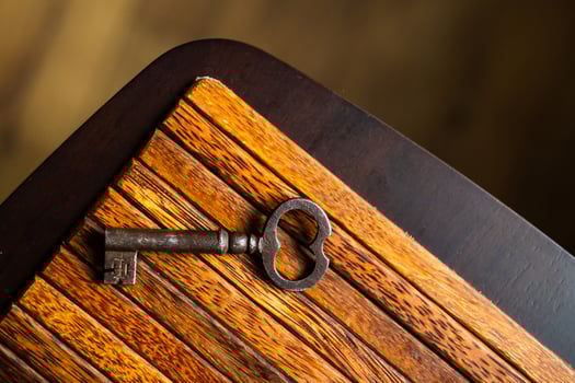 the old key lies on an old wooden table, natural textures, the concept of discoveries, secrets, answers photo