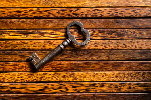 the old key lies on an old wooden table, natural textures, the concept of discoveries, secrets, answers photo