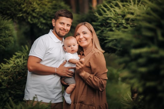 Happy family of three in the summer in the park in nature photo