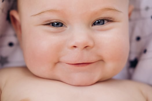 Close-up of the face of a cute baby lying in photo