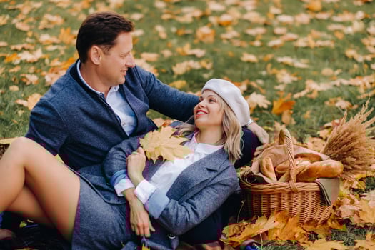 Happy couple enjoying golden autumn spring season in the park photo