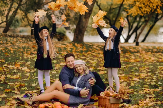 A big family on a picnic in the fall in a nature park. Happy people in the autumn park photo