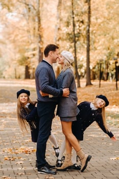 A large family walks in the park in the fall. Happy people in the autumn park photo