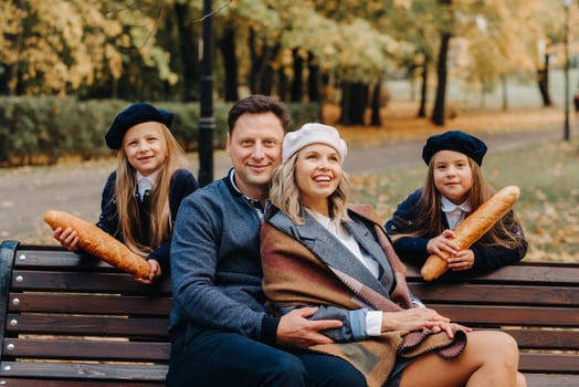 A large family is sitting on a bench in an autumn park. Happy people in the autumn park photo