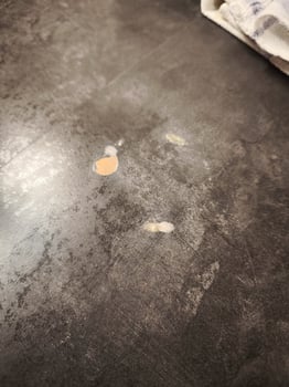 Damaged countertop showing peeling laminate and particleboard underneath photo