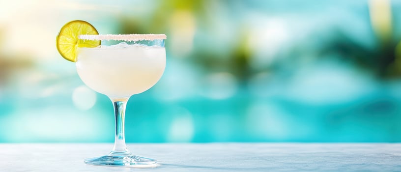 Refreshing frozen margarita with salted rim and lime garnish, perfect for summer enjoyment by poolside photo