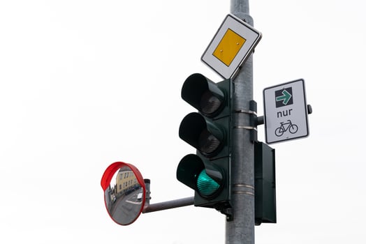 A traffic light showing green, with a bicycle sign indicating a bike photo
