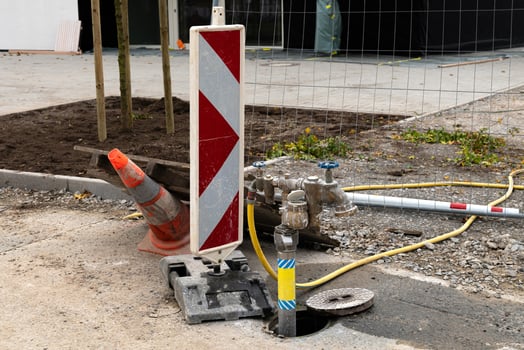 Workers prepare a construction site with a warning signal, an orange photo