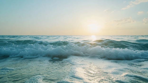The ocean is calm and the sun is setting photo
