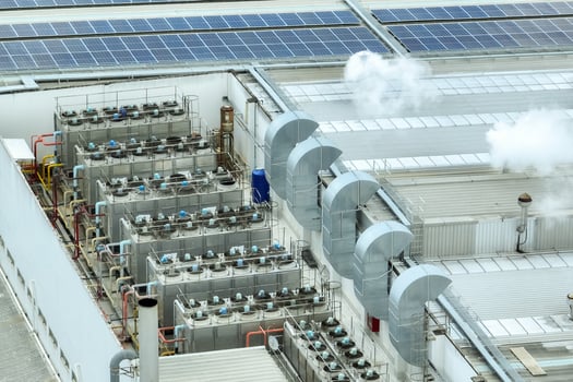 Sustainable industrial rooftop. Aerial view showcasing solar panels, ventilation systems, and industrial chillers. Renewable energy and efficient cooling in modern manufacturing facilities. photo