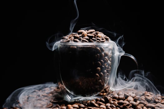 Coffee beans that have been roasted in glass cup photo