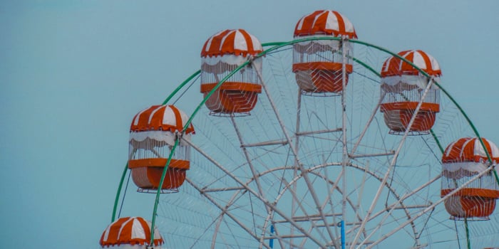A ferris wheel with orange and white stripes photo
