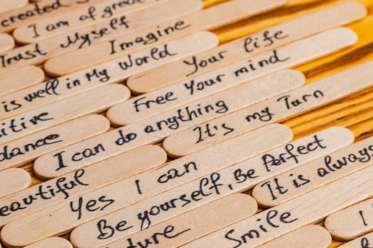 Positive thoughts for increasing selfesteem on wooden posts on wooden background photo