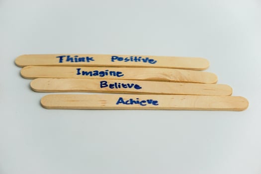 handwriting messages on ice cream sticks in close-up as a concept for building self-esteem photo