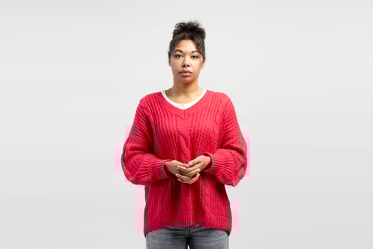 Young woman wearing red sweater posing on white background photo