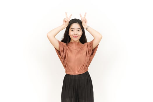 Showing Peace Sign Of Beautiful Asian Woman Isolated On White Background photo