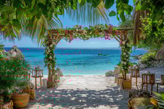 Wedding arch decorated with dahlias and tropical flowers on beach photo
