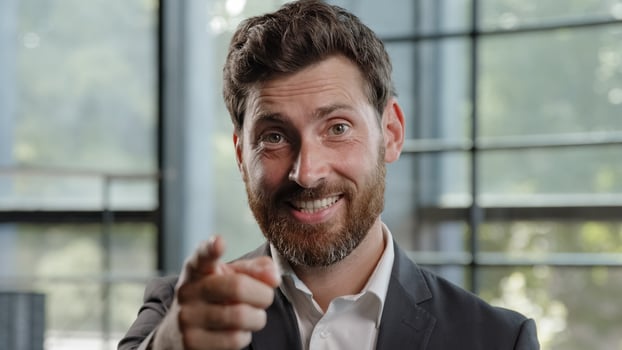 Confident 40s Caucasian happy smiling leader man boss leader HR manager businessman make job offer point index finger camera hey you motivation gesture show agree approve yes support choosing select photo